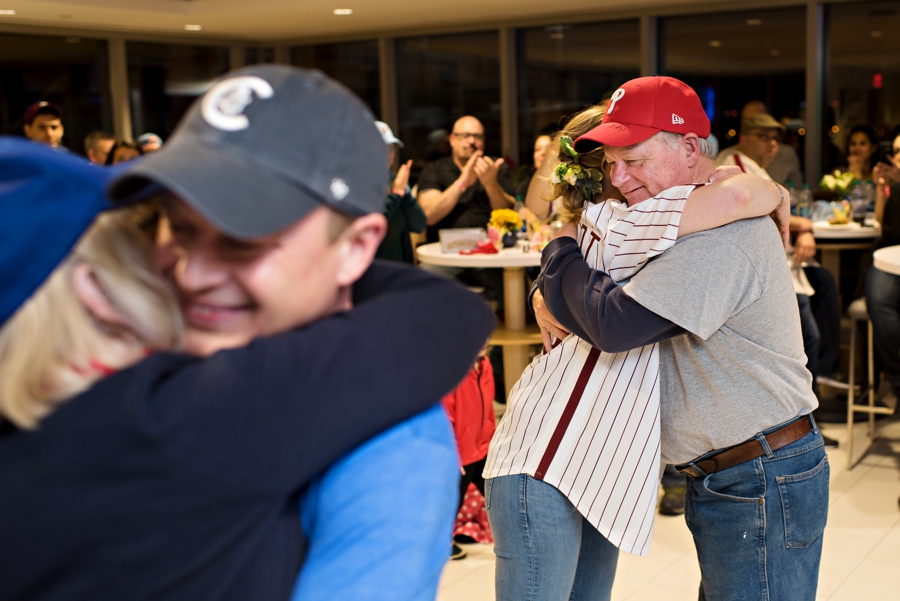 A bride and groom hug their parents after they danced in the Phillies suite while Take me out the ball game played during half time.